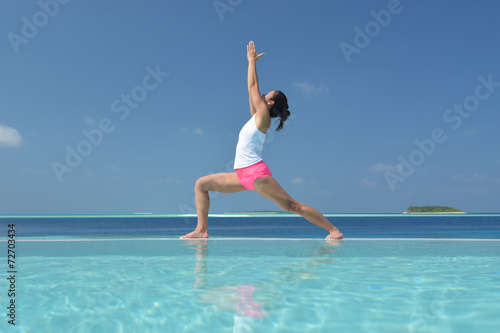 Asian chinese woman practising yoga by the sea © 1000words