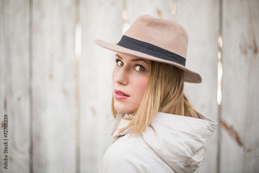 Pretty blonde woman with hat looking over her shoulder Pretty blonde woman with hat looking over her shoulder
