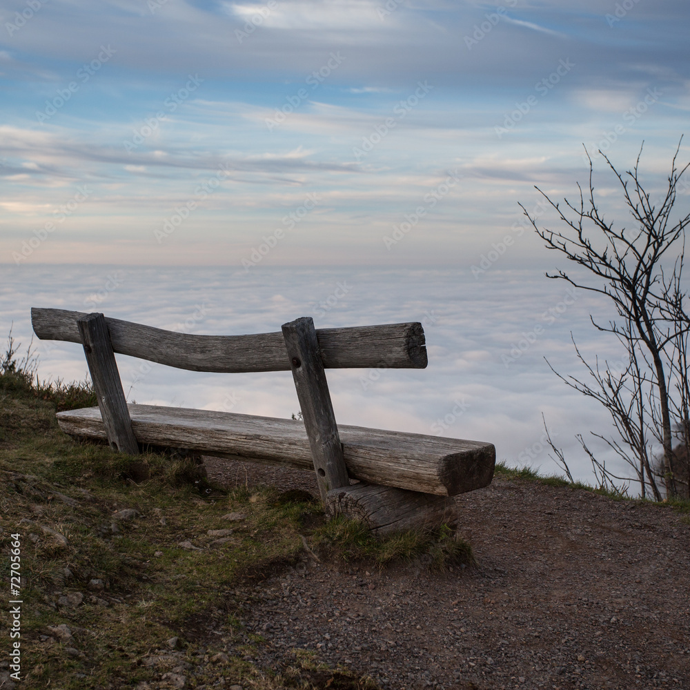 wooden bench above inversion fog in black forest, Germany