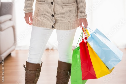 Mid section of woman holding shopping bags