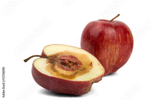 rotten sliced red apple on a white background