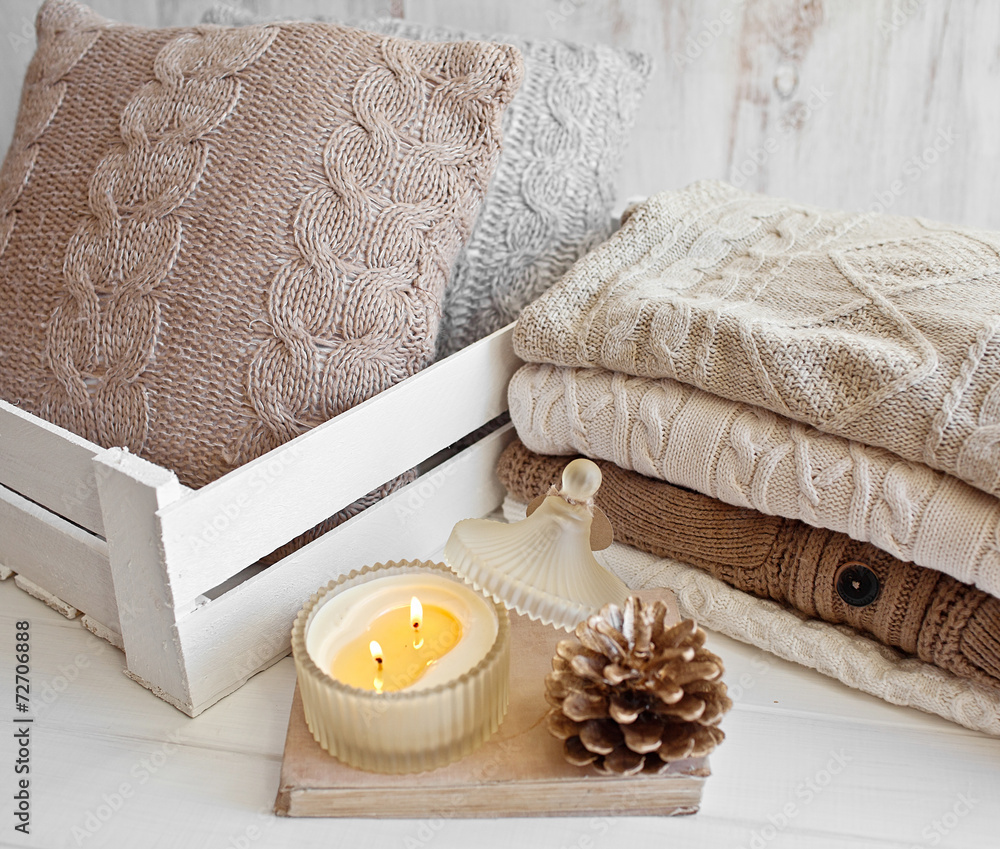 Cozy wool winter accessory. Warm sweaters, cone and candle