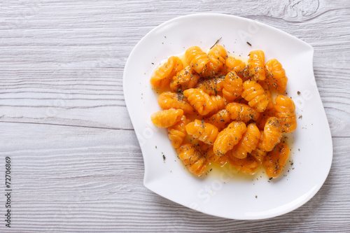 pumpkin gnocchi with sauce and spices, horizontal top view