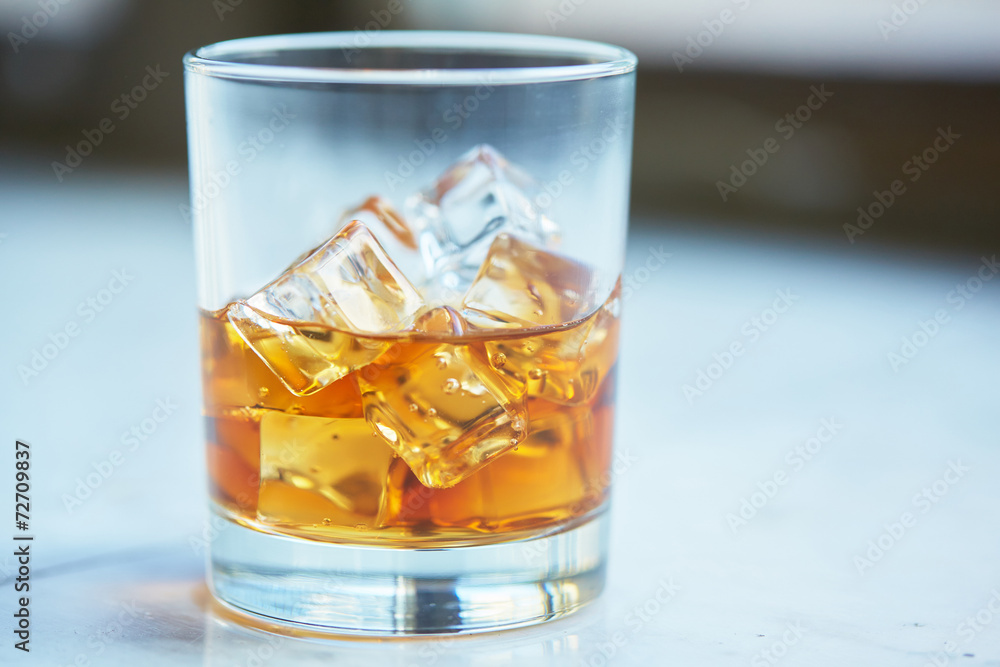 whiskey with ice on a table