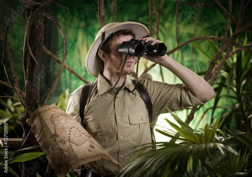 Explorer in the jungle with binoculars