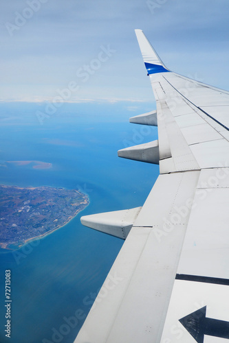 Looking through window aircraft during flight in wing.