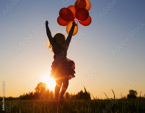 girl with balloons jumping outdoor photo