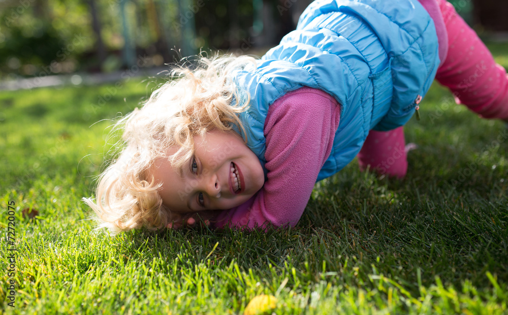 Portrait of cute blonde little girl playing outdoors Portrait of cute blonde little girl playing outdoors