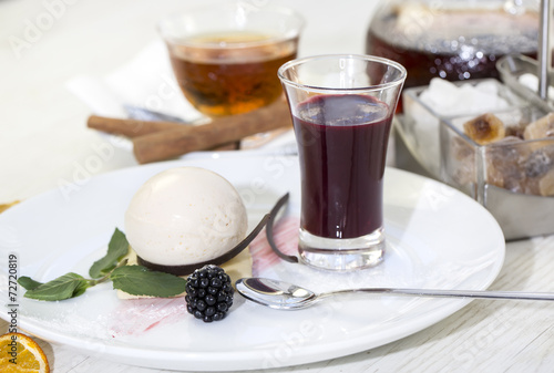 creamy dessert is decorated with blackberries