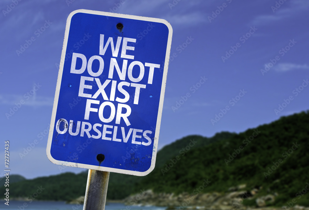 We Do Not Exist for Ourselves sign with a beach