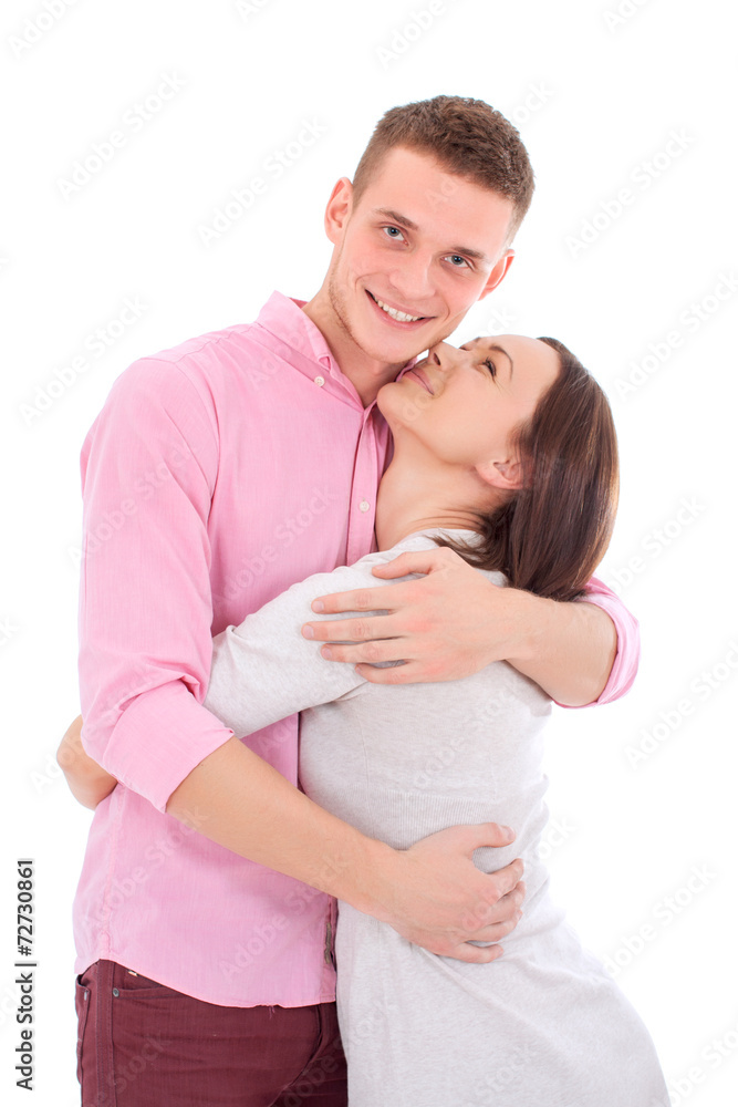 A young couple standing together and hugging. A young couple standing together and hugging.