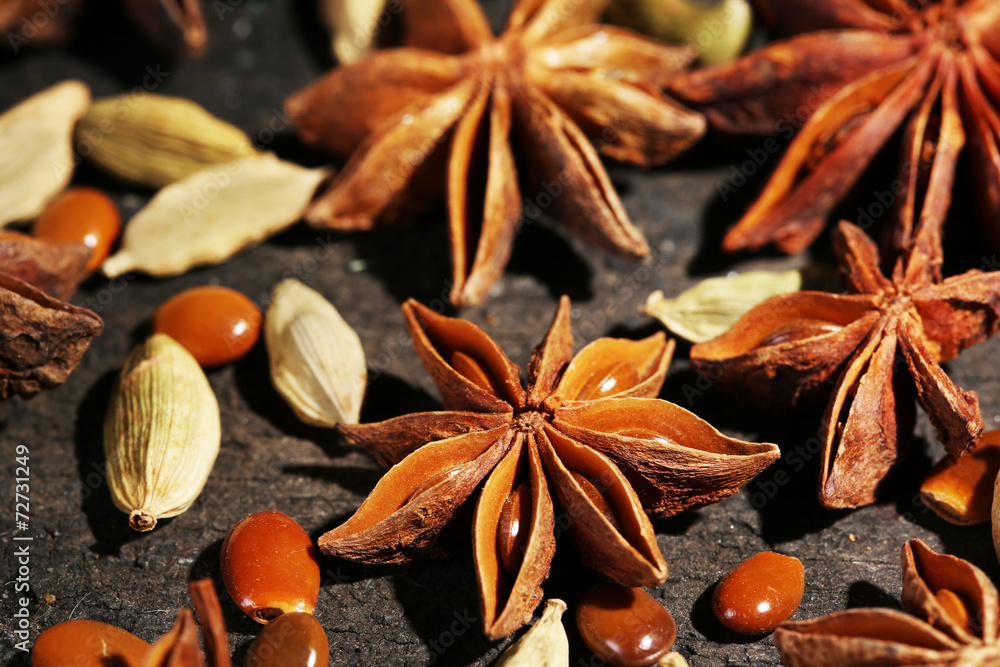 Stars anise and cardamom on wooden background Stars anise and cardamom on wooden background