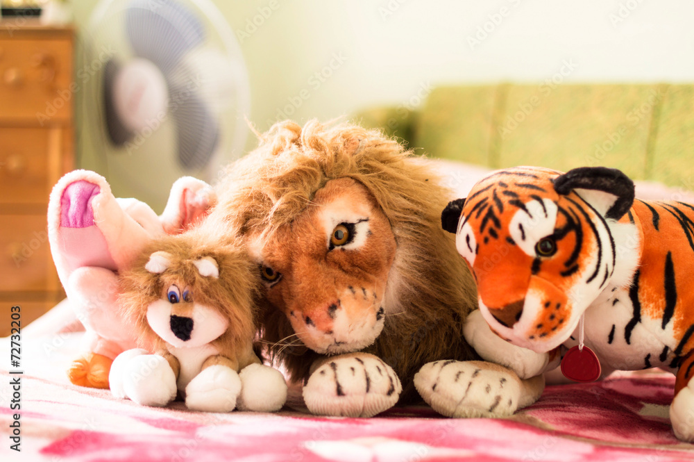 Different soft toys for children on the couch