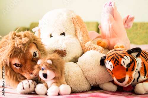 Different soft toys for children on the couch © gorvik