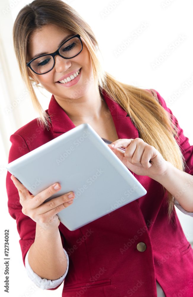 Young smiling woman using digital tablet. Isolated on white. Young smiling woman using digital tablet. Isolated on white.