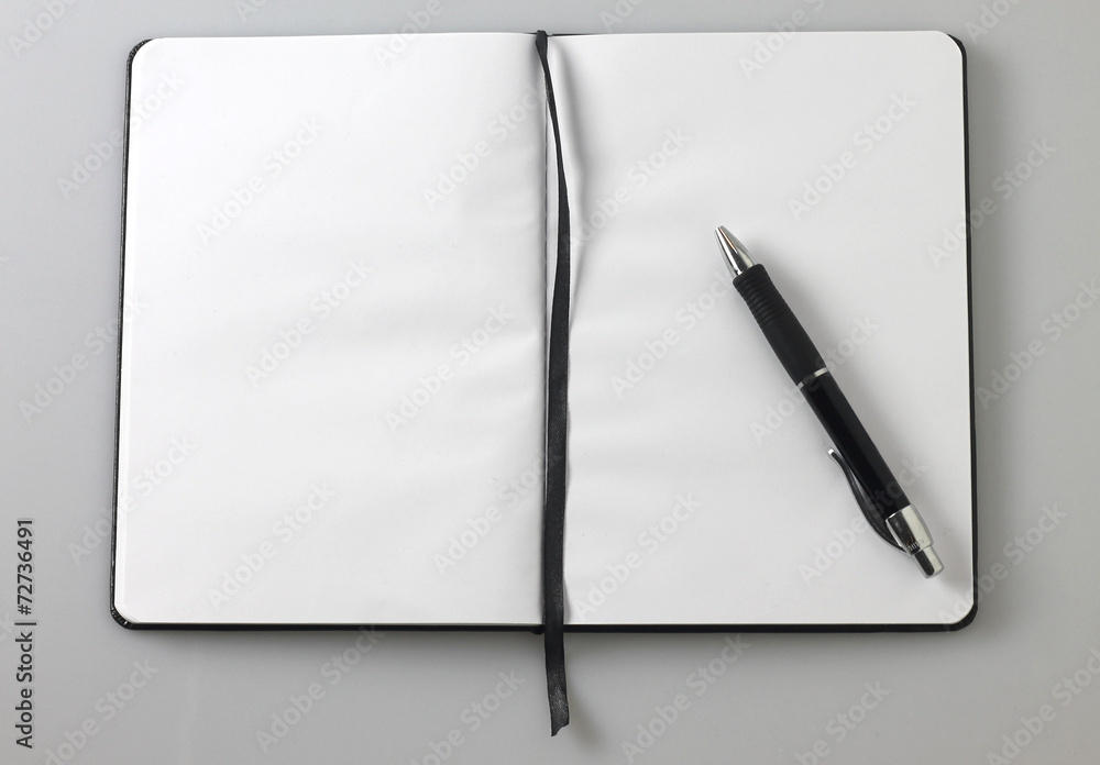 white blank notebook and black pen, background with copy space white blank notebook and black pen, background with copy space