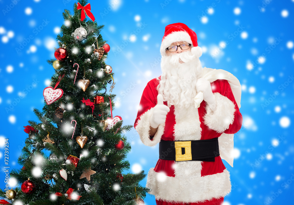 santa claus with bag and christmas tree