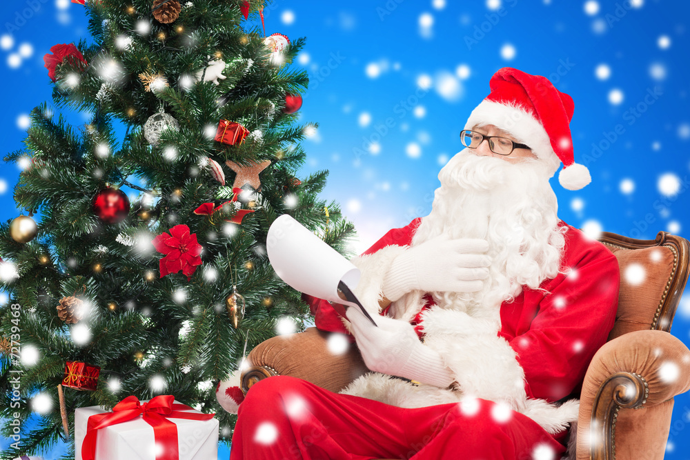 man in costume of santa claus with notepad man in costume of santa claus with notepad