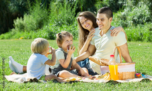 parents with daughters having picnic