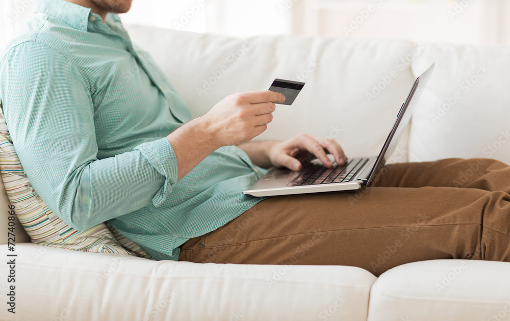 close up of man with laptop and credit card close up of man with laptop and credit card