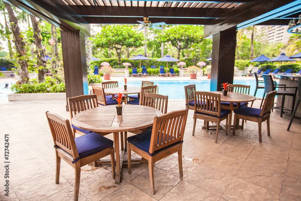 Fototapeta premium Summer empty open air cafe near swimming pool