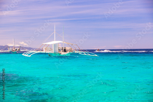 Big catamaran in turquoise open sea near Bohol island