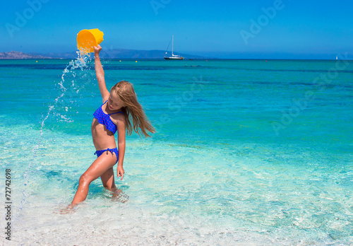 Little happy girl enjoying beach vacation