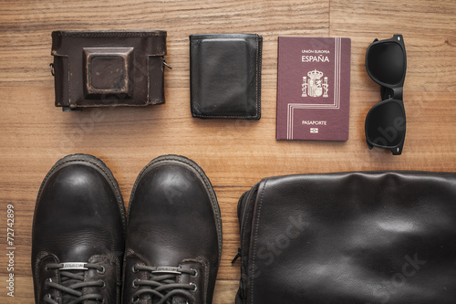 Set with boots, old camera, sunglasses, wallet and passport