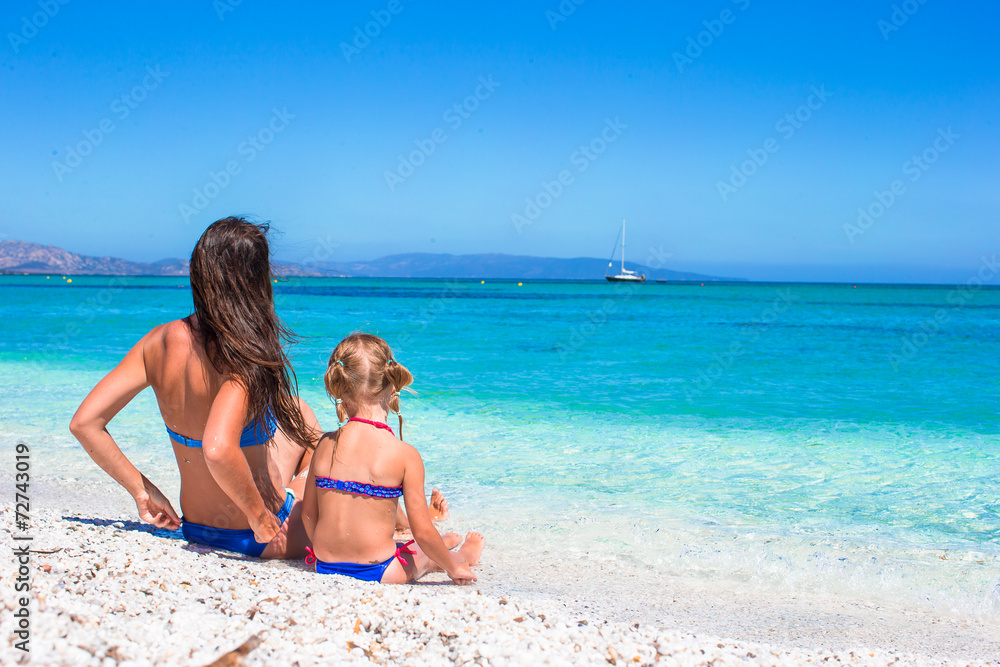 Young mother and adorable little girl during summer vacation
