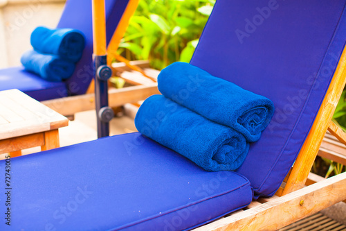 Fototapeta Close-up of towels near swimming pool at tropical resort