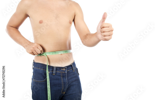 Young man on isolated background with a tape measure