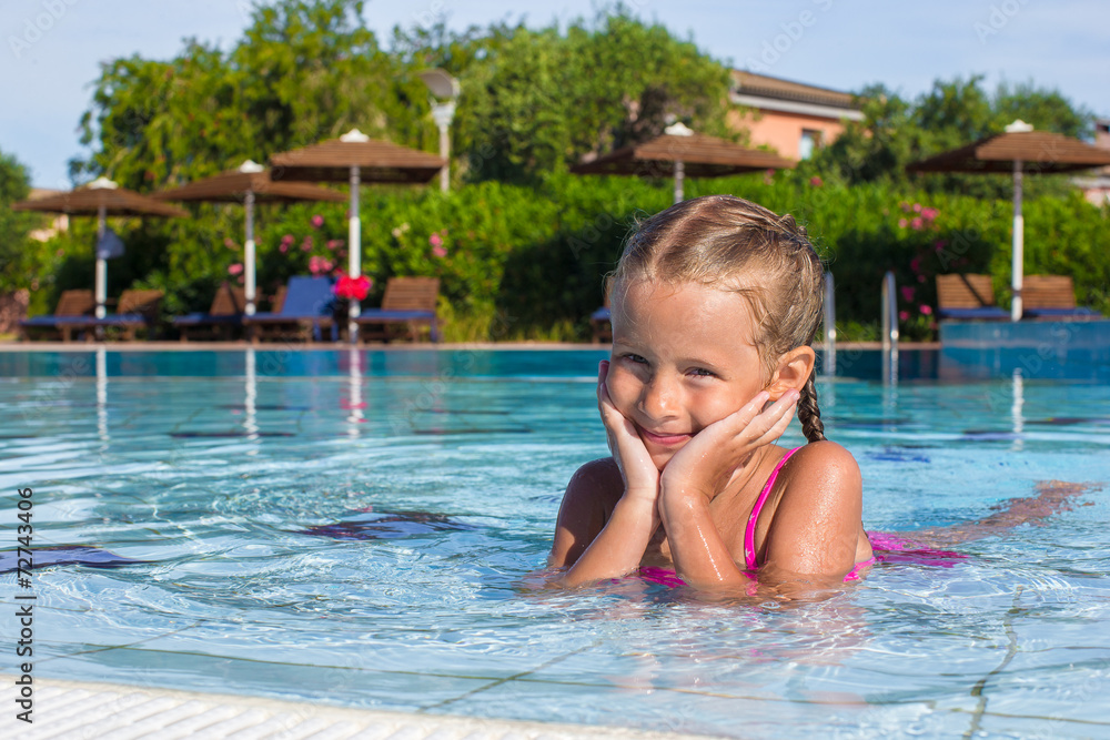 Adorable happy little girl enjoy swimming in the pool