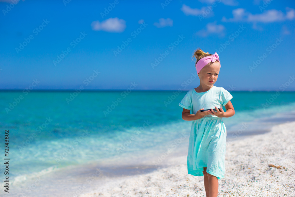 Adorable little girl at tropical beach during summer vacation Adorable little girl at tropical beach during summer vacation