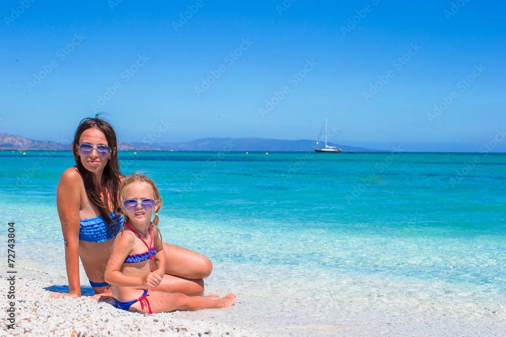 Happy mom and her adorable little daughter during summer
