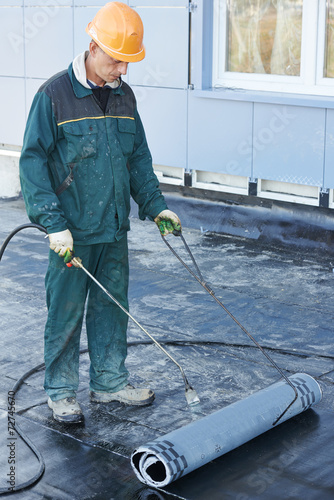 Flat roof covering repair works with roofing felt