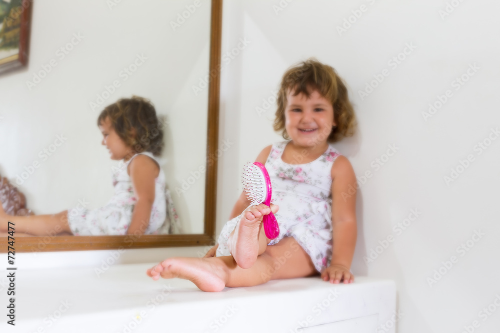 young beautiful child girl looking at herself in mirror at home young beautiful child girl looking at herself in mirror at home