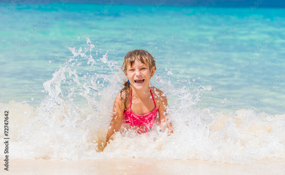 young happy child girl having fun in water, tropical summer vaca young happy child girl having fun in water, tropical summer vaca