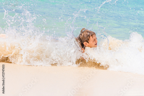 young happy child boy having fun in water  tropical summer vacat