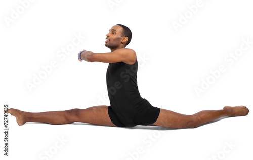 male ballet dancer warming up and showing flexibility photo