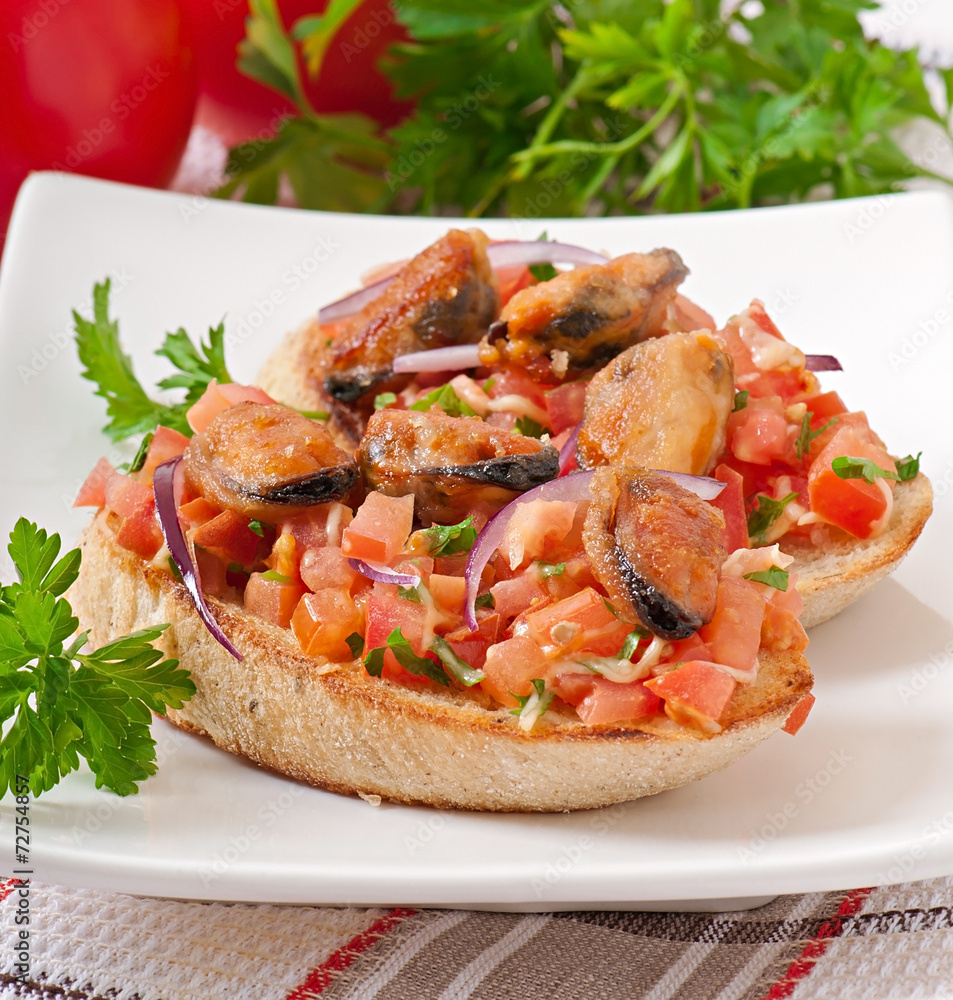 Bruschetta with mussels, cheese and tomatoes
