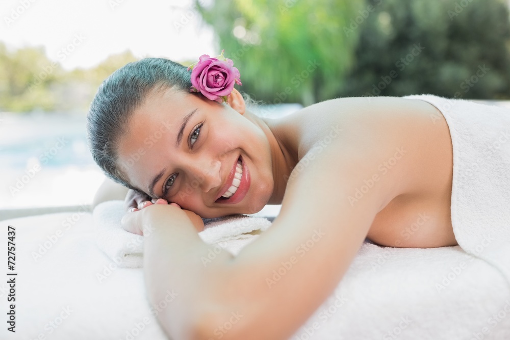 Obraz premium Beautiful woman lying on massage table at spa center