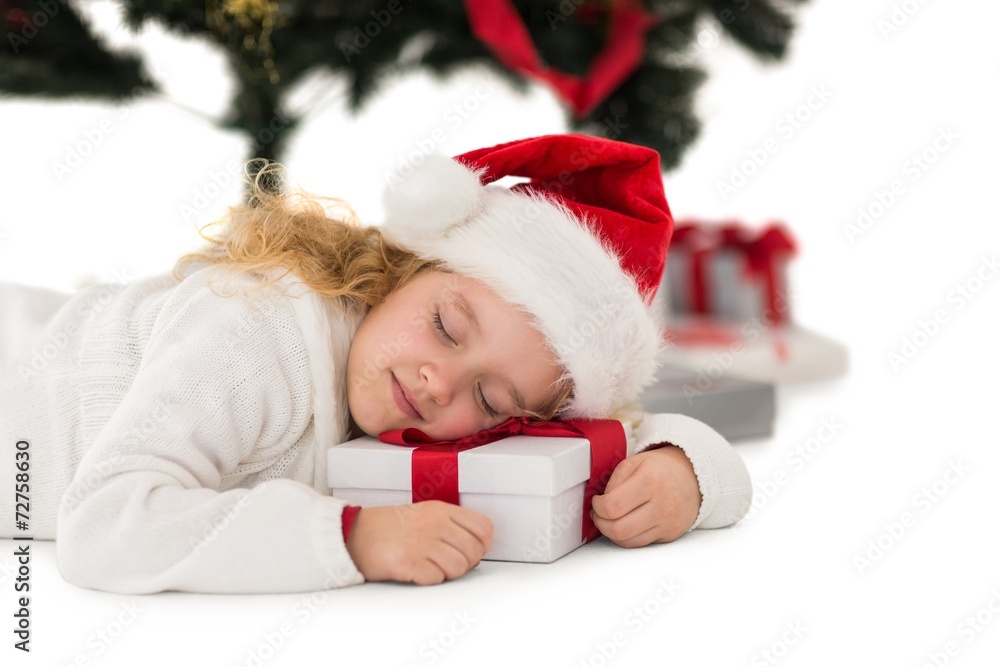 Festive little girl napping on a gift Festive little girl napping on a gift