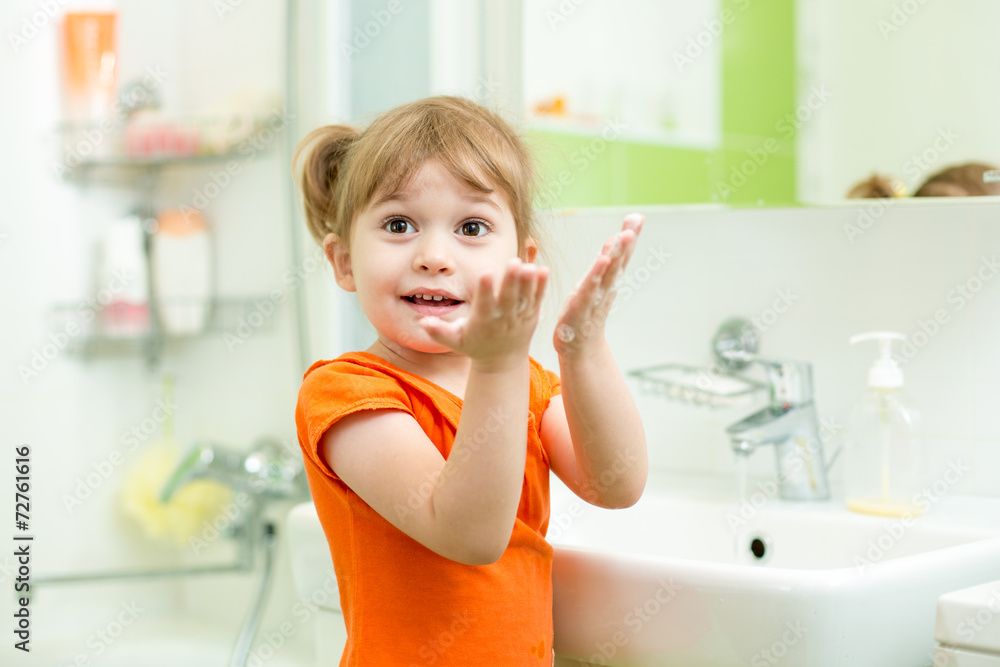 Cute little girl washing hands in bathroom Cute little girl washing hands in bathroom