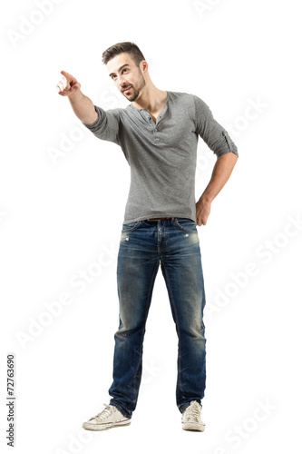 Serious man pointing at someone in the distance