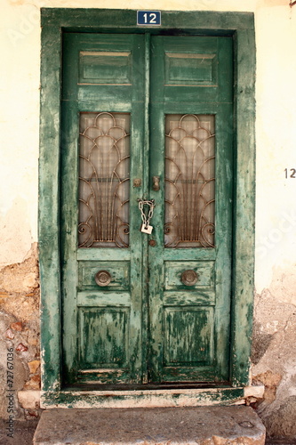 Distressed green flaking painted doors  © William Richardson