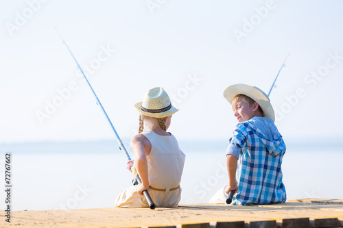 Boy and girl with fishing rods