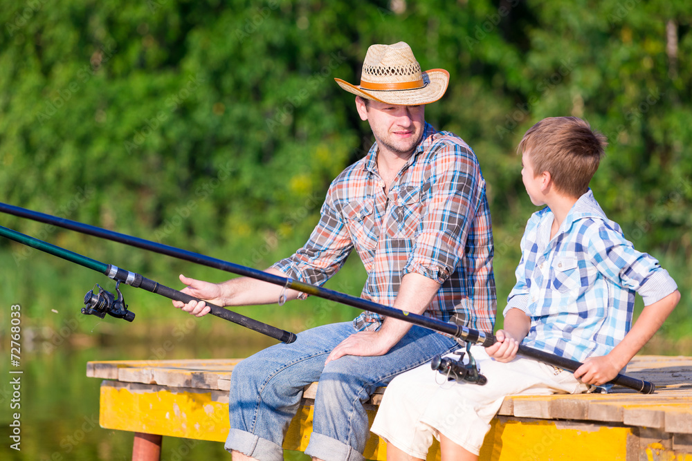 boy and his father fishing togethe boy and his father fishing togethe