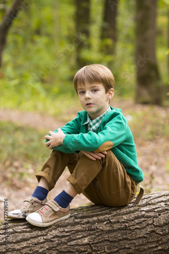 Portrait of a boy on a background of green nature