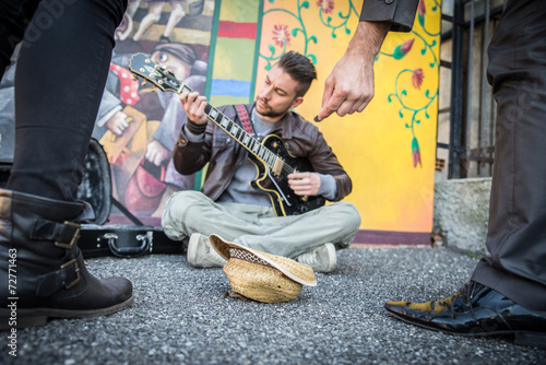 Street artist playing guitar on the streets