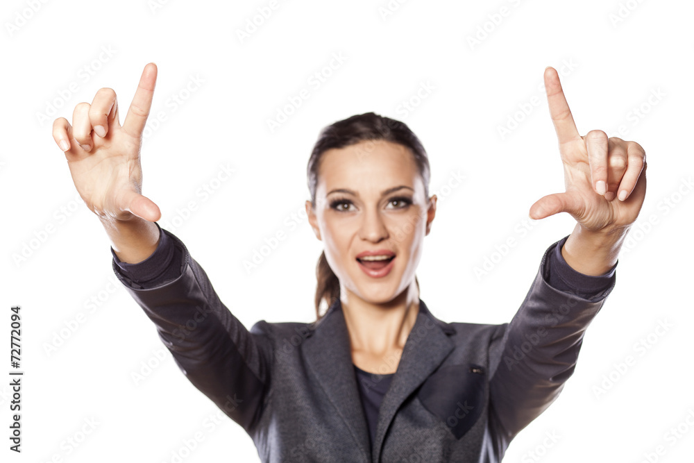 Smiling business woman shows with her fingers in the blank Smiling business woman shows with her fingers in the blank